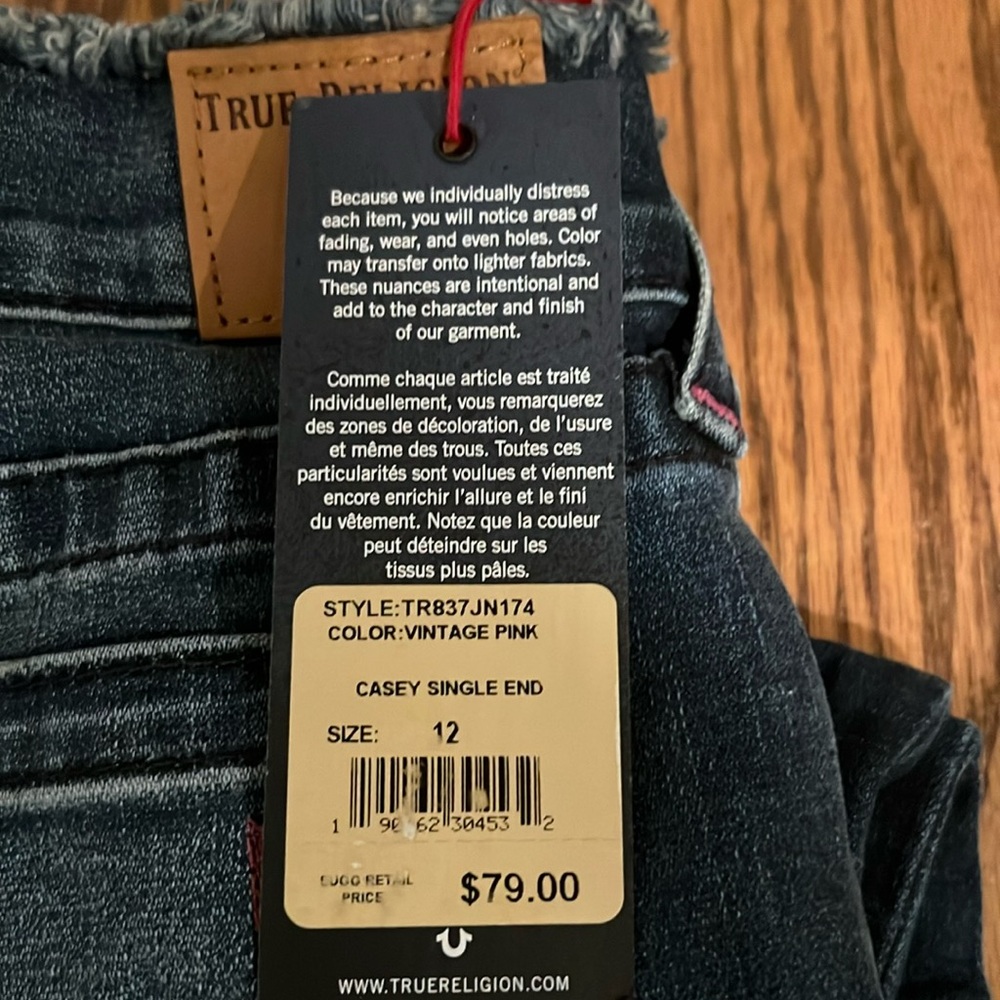 New with tags.  Denim jeans with pink stitching. Size 12
